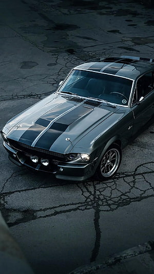 Classic Ford Mustang Shelby GT500 with racing stripes on cracked asphalt HD phone wallpaper