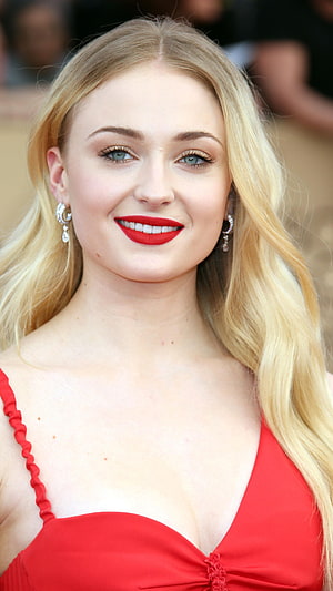 Sophie Turner in a red dress with bold red lipstick and diamond earrings HD phone wallpaper