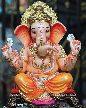 Ganesha Murti with Golden Crown and Orange Dhoti in Seated Pose HD phone wallpaper