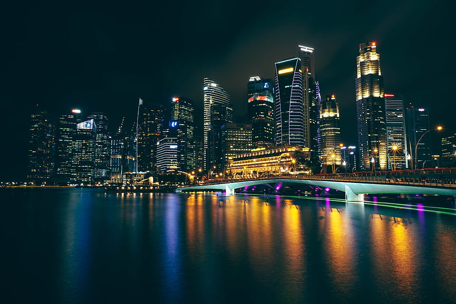 Illuminated Singapore skyline at night with Marina Bay Sands and bridge reflections on the water HD wallpaper