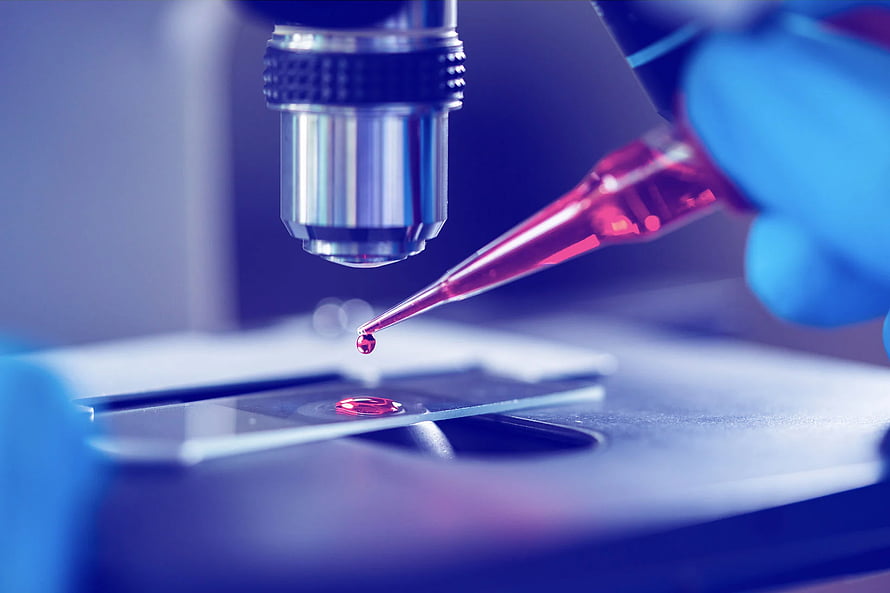 Scientist Using Pipette to Place Red Liquid Drop on Microscope Slide HD wallpaper