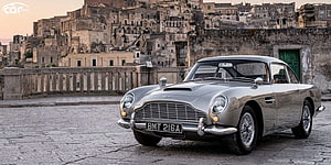 Classic Silver Aston Martin DB5 Parked in Historic Italian Town Square HD wallpaper
