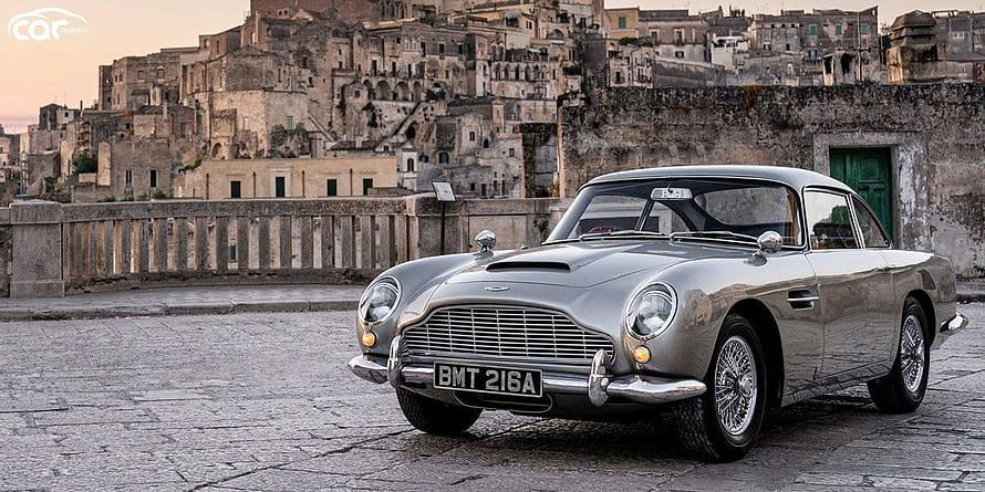 Classic Silver Aston Martin DB5 Parked in Historic Italian Town Square HD wallpaper