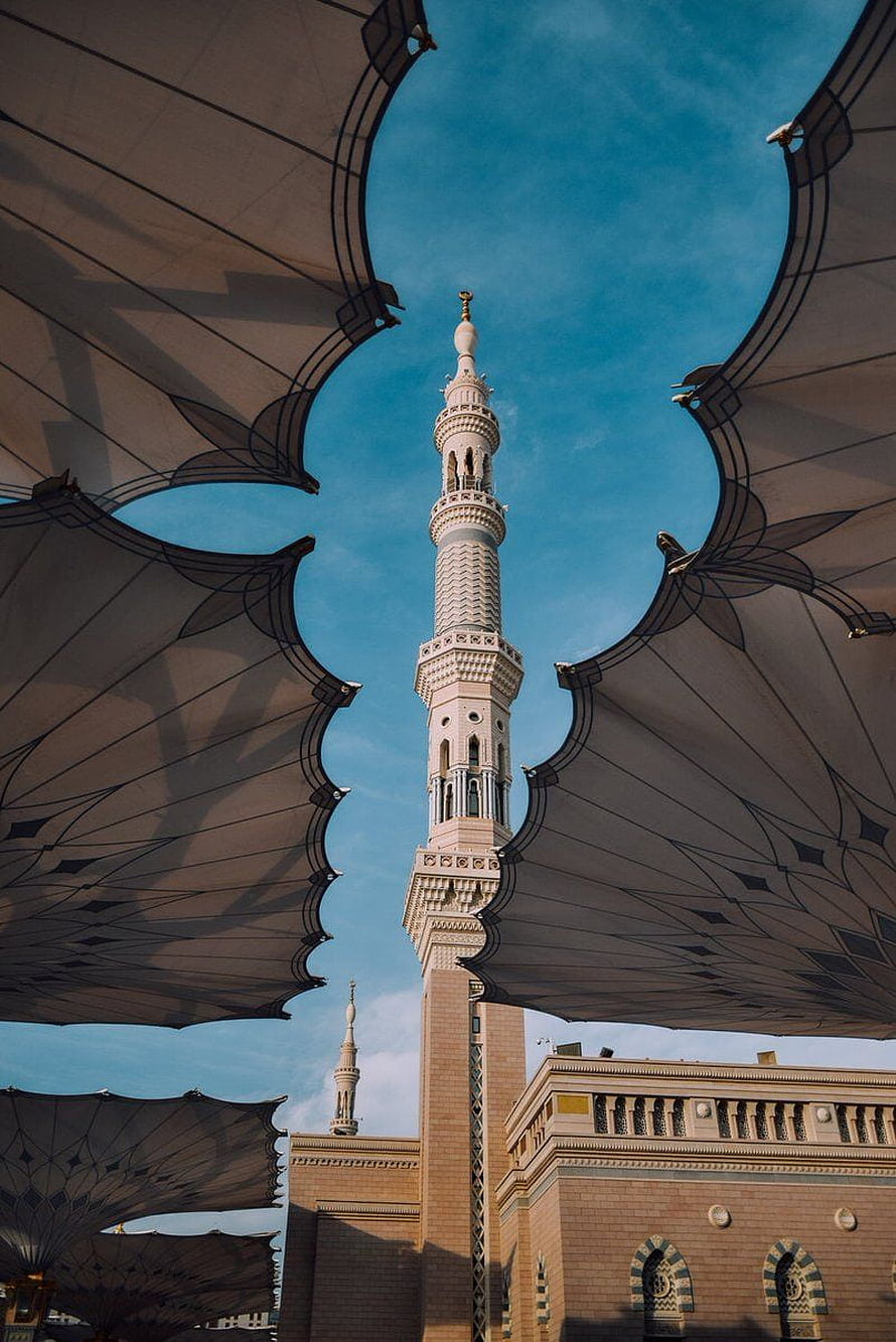 Makkah Grand Mosque Minaret Framed by Canopy Against Blue Sky HD phone wallpaper