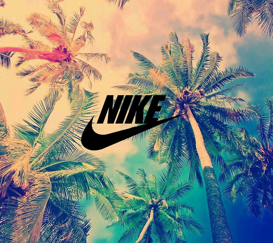 Nike Logo Over Tropical Palm Trees Against a Warm Sunset Sky HD wallpaper