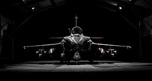 Dassault Rafale Fighter Jet Front View in Dark Hangar with Dramatic Lighting HD wallpaper