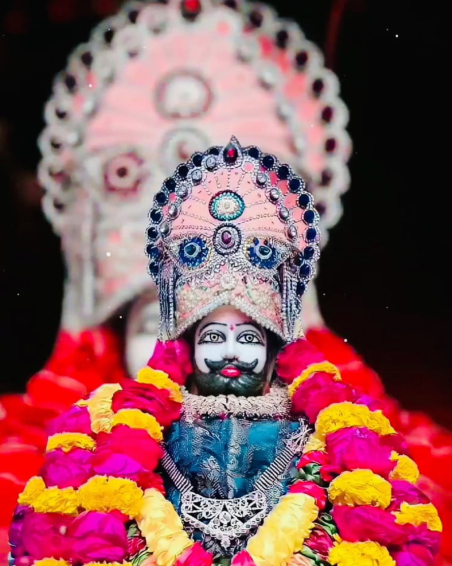 Ornate Hindu Deity Idol Adorned With Jeweled Crown And Vibrant Flower Garlands HD phone wallpaper