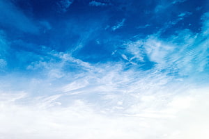 Vast blue sky with wispy white clouds and bright sunlight HD wallpaper