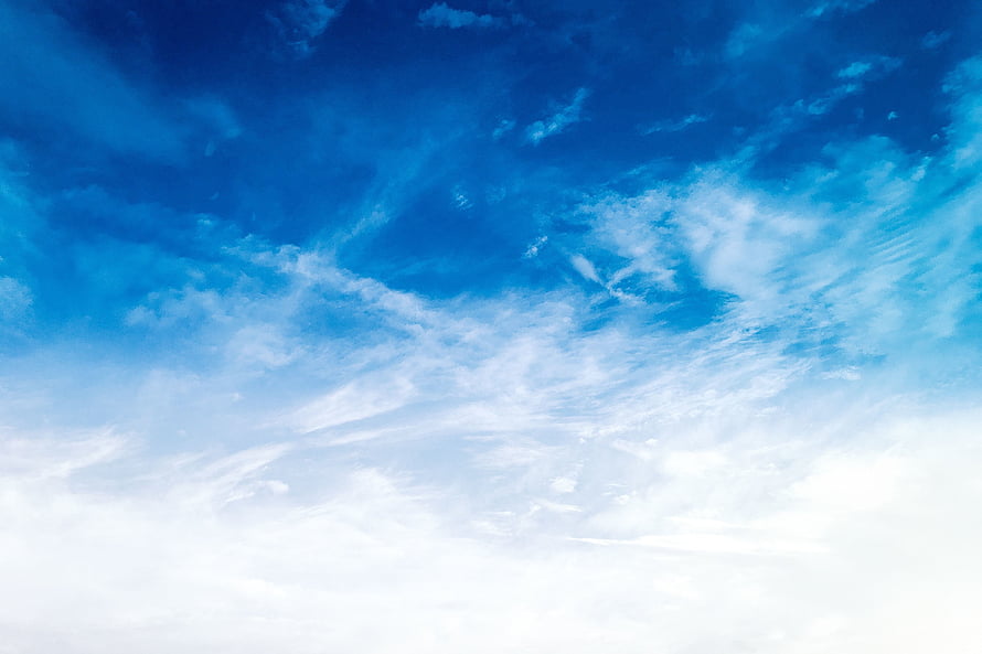 Vast blue sky with wispy white clouds and bright sunlight HD wallpaper
