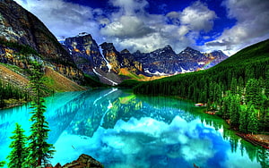 Turquoise Mountain Lake Reflecting Snow-Capped Peaks and Dense Evergreen Forest HD wallpaper