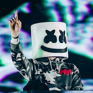 Marshmello performing on stage in a white helmet and camouflage hoodie HD phone wallpaper