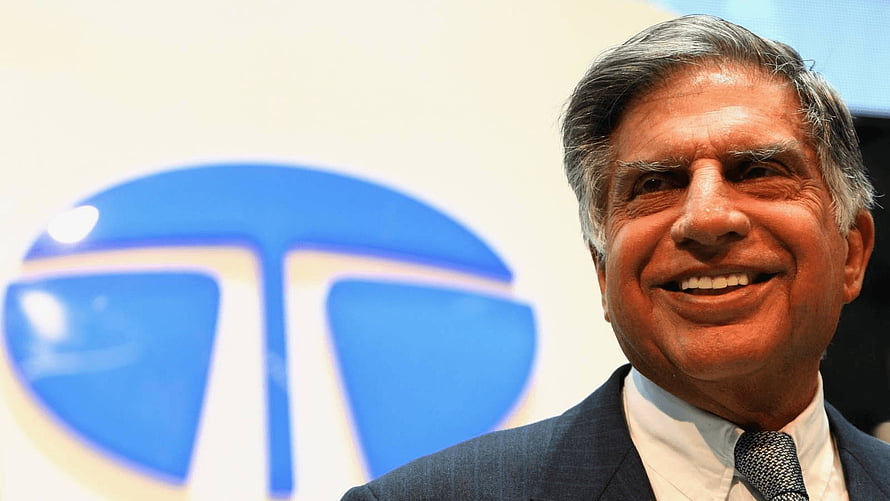 Ratan Tata smiling in a suit with the Tata Group logo in the background HD wallpaper