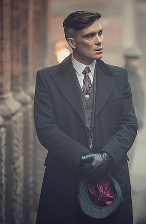 Thomas Shelby from Peaky Blinders in a dark coat holding a hat HD phone wallpaper