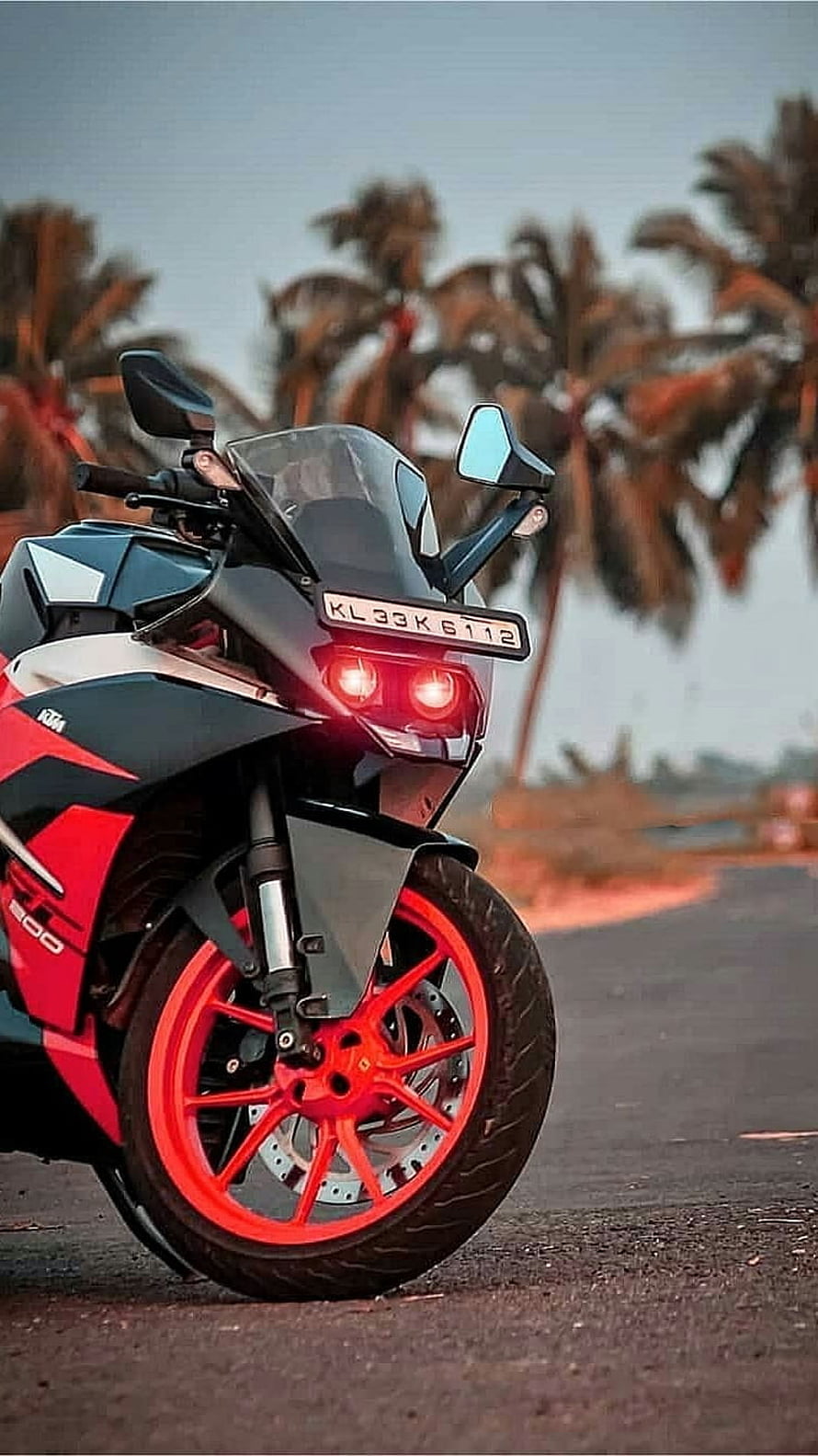 KTM RC 390 Sport Motorcycle with Red Wheels Parked on a Road Near Palm Trees HD phone wallpaper