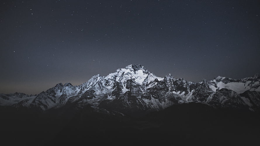 Snowy Mountain Range Under Starry Night Sky HD wallpaper