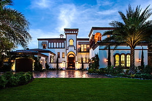 Mediterranean Style Luxury Mansion With Palm Trees And Illuminated Facade At Dusk HD wallpaper