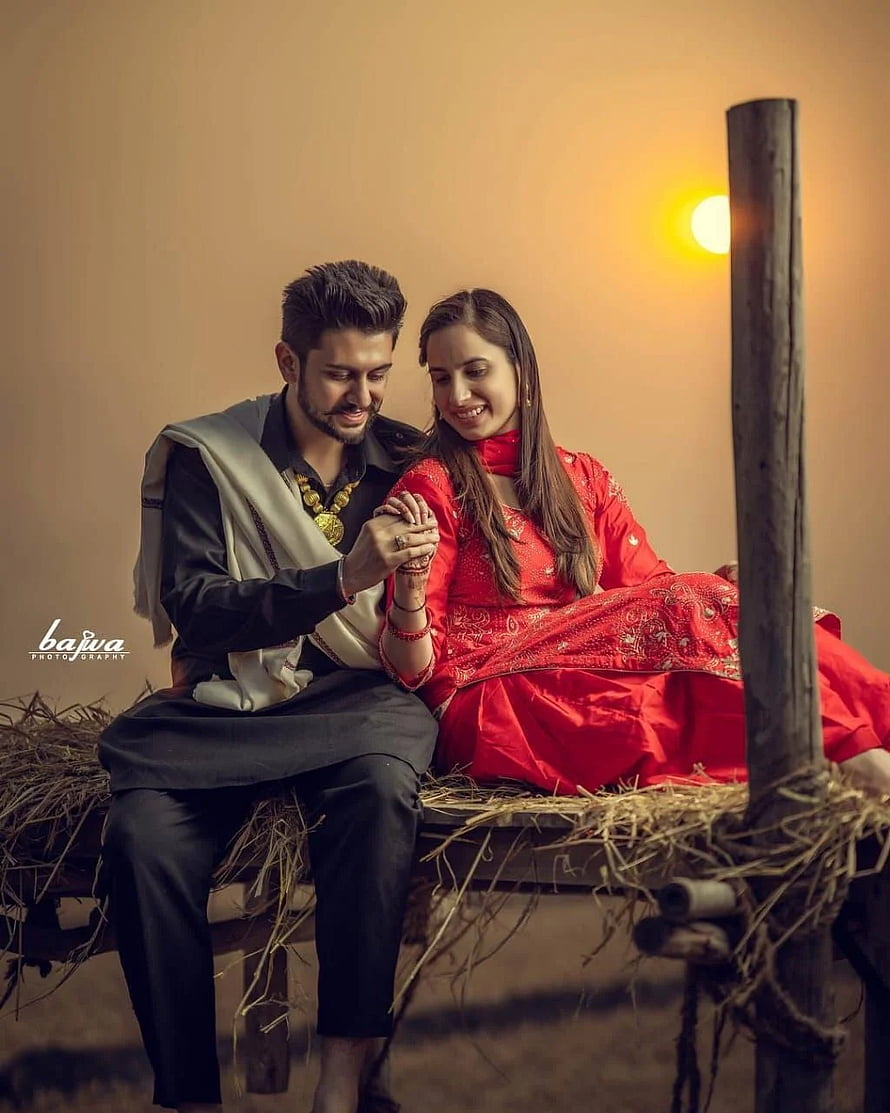 Romantic Punjabi Couple in Traditional Attire Sitting on Hay Bale HD phone wallpaper