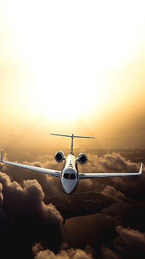 Luxury Private Jet Cruising Above Golden Clouds at Sunset HD phone wallpaper