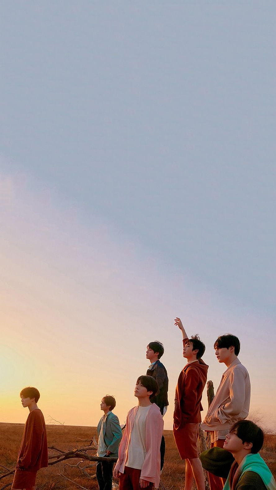 Seventeen members standing in a field at sunset looking up at the sky HD phone wallpaper