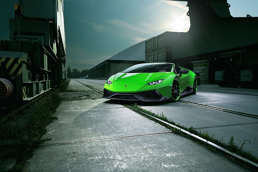 Vibrant Green Lamborghini Huracan Parked in Industrial Rail Yard HD wallpaper