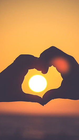 Silhouette of Hands Forming Heart Shape Around Setting Sun HD phone wallpaper