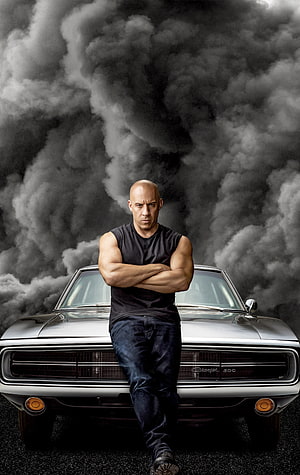 Vin Diesel as Dominic Toretto leaning on a Dodge Charger with smoke background HD phone wallpaper