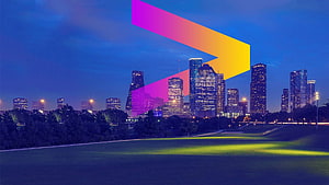 Dallas skyline at night with a large colorful gradient arrow overlay on a grassy park foreground HD wallpaper
