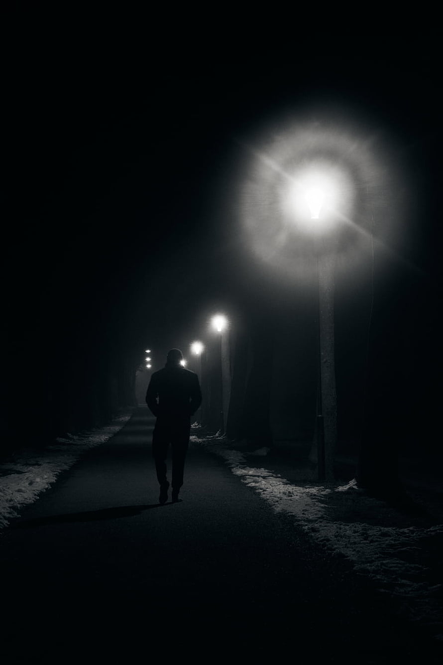 Silhouette Walking a Snowy Path at Night Under Streetlights HD phone wallpaper