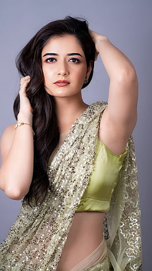 Ashika Ranganath in a shimmering sequined saree with a lime green blouse HD phone wallpaper