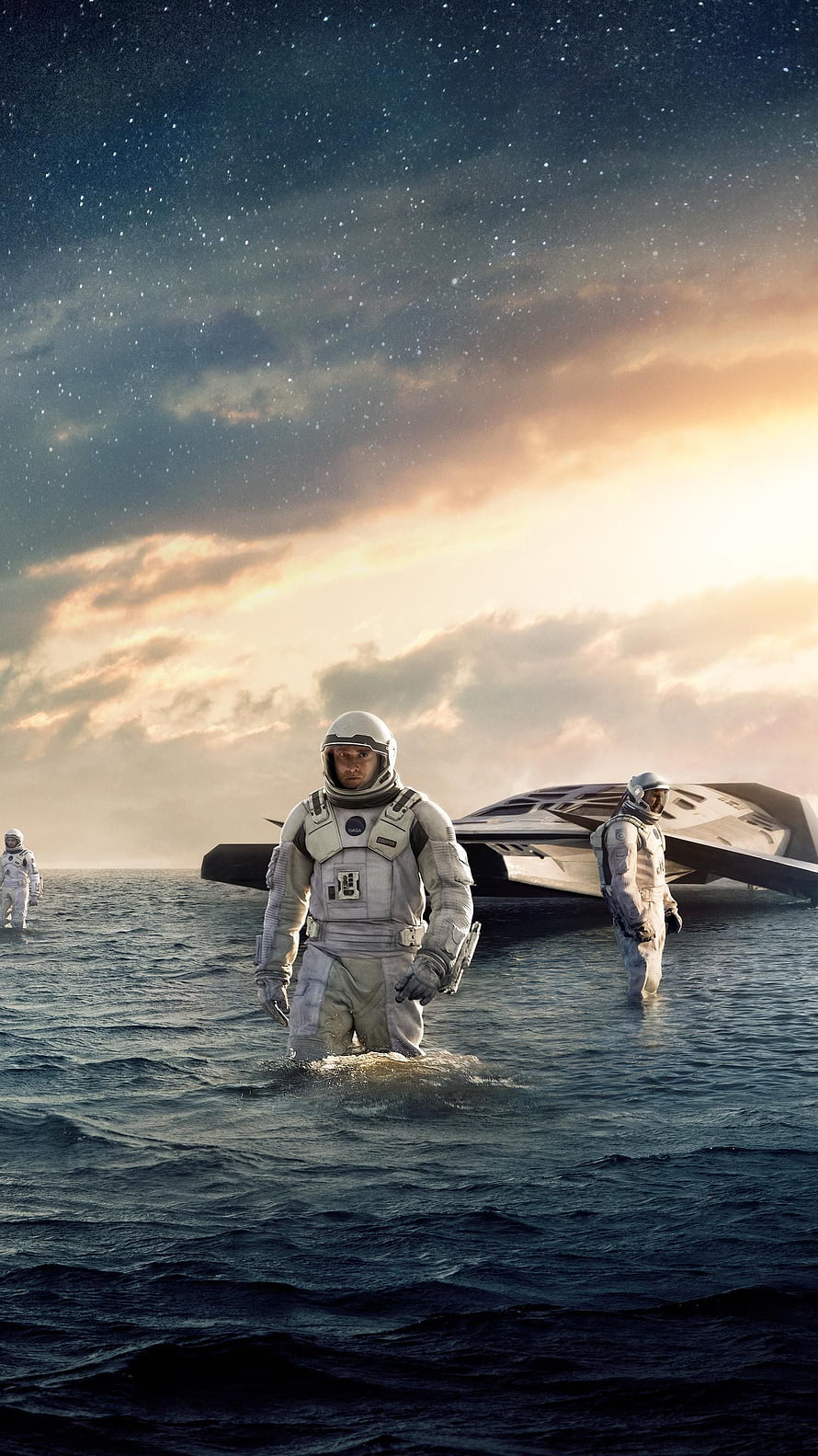 Interstellar astronauts wading through water with spacecraft under a starry sky HD phone wallpaper