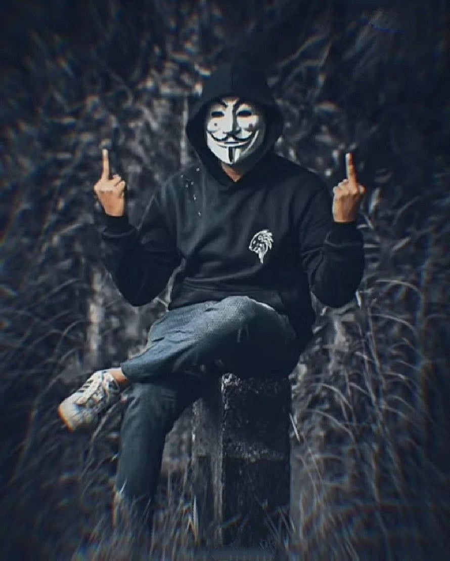 Anonymous Hacker Wearing Guy Fawkes Mask and Black Hoodie Sitting on Concrete Block HD phone wallpaper