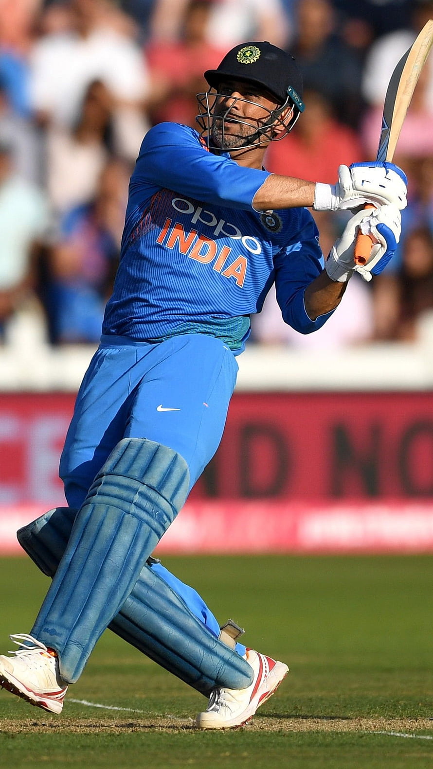 MS Dhoni in action wearing the blue India cricket jersey and batting gear HD phone wallpaper
