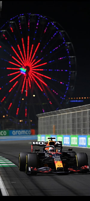 Max Verstappen Red Bull Racing Formula 1 Car at Night with Illuminated Ferris Wheel HD phone wallpaper