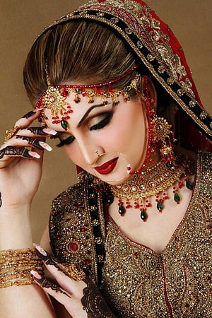 Elegant Indian Bride in Traditional Red and Gold Wedding Attire with Intricate Jewelry HD phone wallpaper