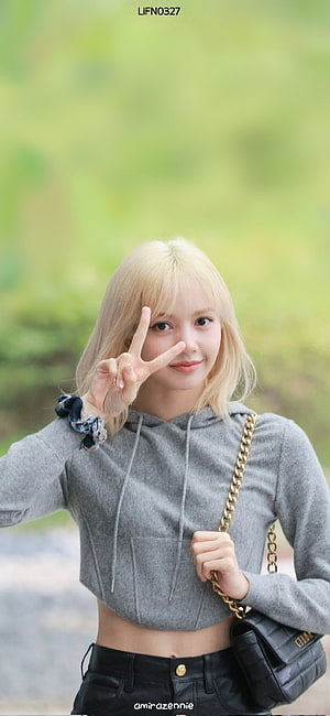 Lisa from BLACKPINK in a grey cropped hoodie and black leather pants with a gold chain bag HD phone wallpaper