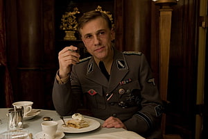 Christoph Waltz as Colonel Hans Landa in Inglourious Basterds at a formal dining table HD wallpaper