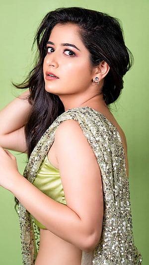 Ashika Ranganath in a shimmering sequined green saree with a satin blouse HD phone wallpaper