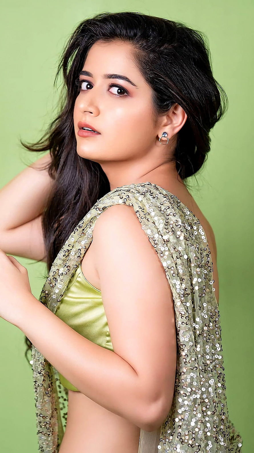 Ashika Ranganath in a shimmering sequined green saree with a satin blouse HD phone wallpaper