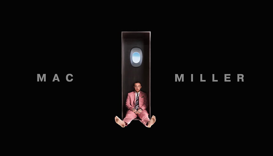 Mac Miller in a Pink Suit Seated Inside a Coffin Against a Black Background HD wallpaper