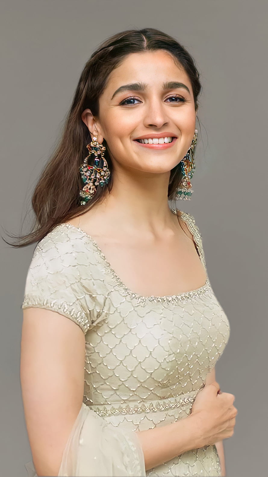 Alia Bhatt in a shimmering gold scale-patterned dress with colorful statement earrings HD phone wallpaper
