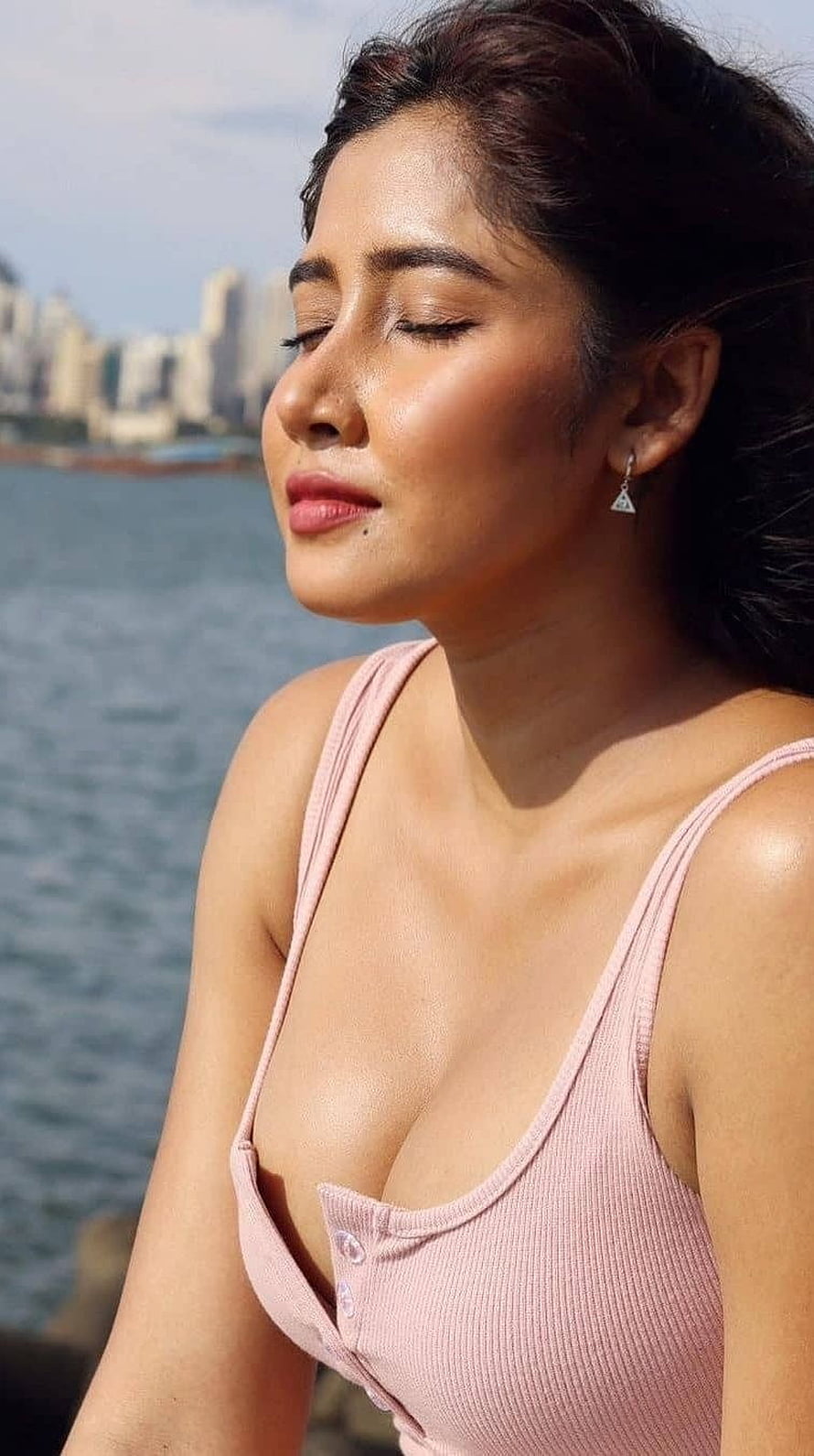 Sara Ali Khan in a pink top with eyes closed near the water HD phone wallpaper