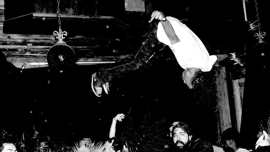 Playboi Carti mid-air crowd surfing at a high-energy live concert HD wallpaper