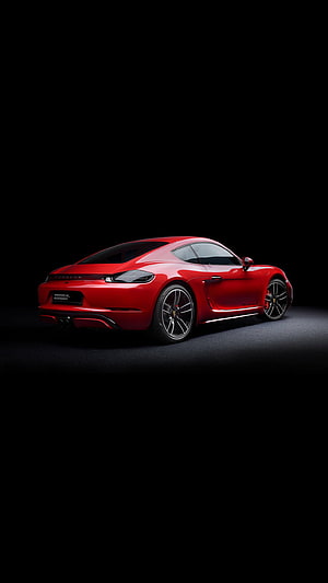 Red Porsche 718 Cayman sports car in a dark studio setting, Cayman. 718 cayman, Super cars, Lux cars, Porsche Amoled HD phone wallpaper