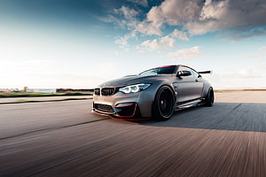 Matte Grey BMW M4 Coupe With Widebody Kit And Rear Wing On Open Road HD wallpaper