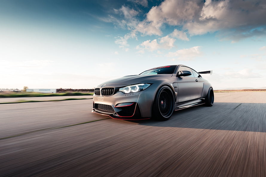 Matte Grey BMW M4 Coupe With Widebody Kit And Rear Wing On Open Road HD wallpaper