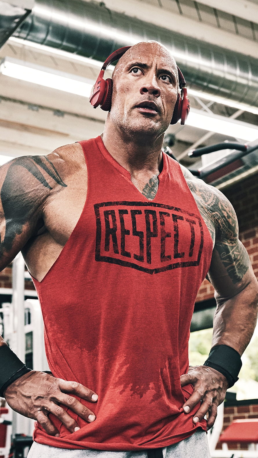 Dwayne Johnson in red Respect tank top and red headphones at the gym HD phone wallpaper