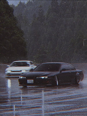 Black Nissan Skyline R33 GT-R and White Supra on Wet Road HD phone wallpaper