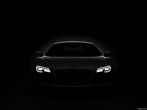 Audi R8 Front View in Dark Studio Setting with Glowing LED Headlights HD wallpaper