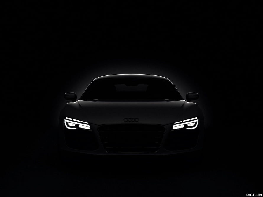 Audi R8 Front View in Dark Studio Setting with Glowing LED Headlights HD wallpaper