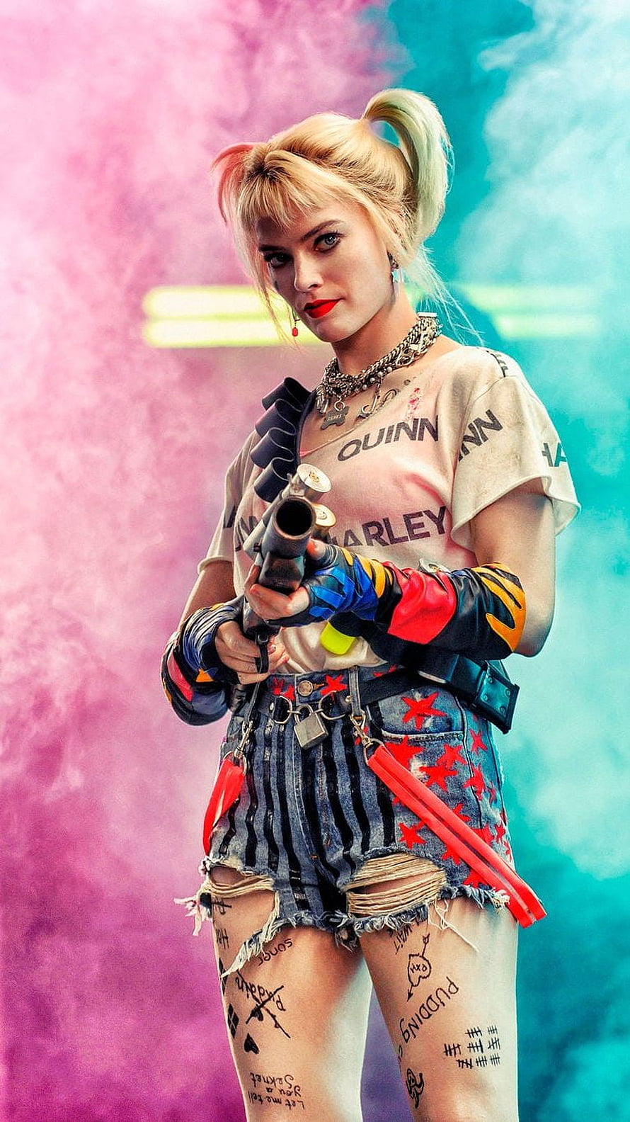 Harley Quinn in colorful punk outfit holding a weapon against pink and blue smoke background HD phone wallpaper